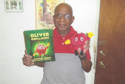 Redefining Retirement - Michael Burns with holding a Book that he wrote